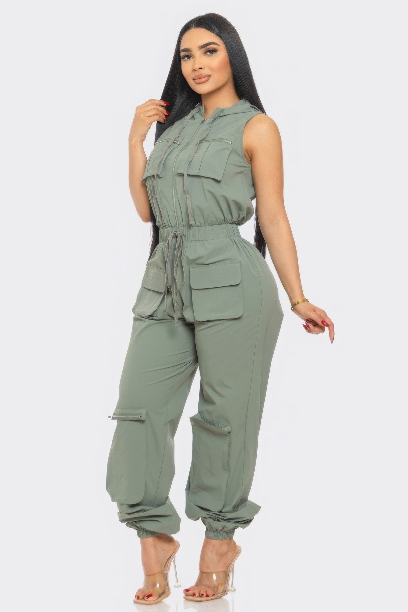 Stylish green utility jumpsuit for travel with multiple pockets and a belted waist for comfort