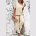 Vacation casual knitwear for women set in beige with black trim featuring a loose top and wide-leg pants