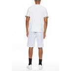 Back view of man wearing white vacation casual shorts for men by WEIV with a white t-shirt and black socks