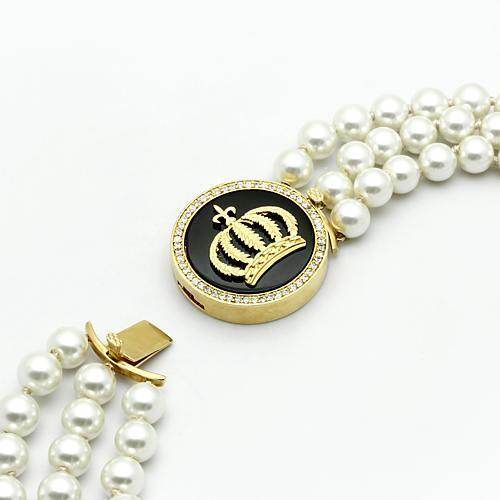Elegant vacation jewelry for women featuring a crown charm and pearl strands for a chic look