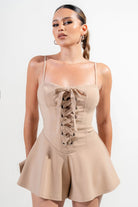 Stylish vacation outfit jumpsuit for women in beige with lace-up details and flared shorts