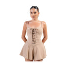 Tan vacation outfit jumpsuit for women with lace-up detail and flared shorts for summer style