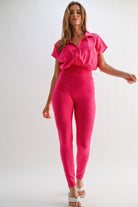 Bright pink vacation outfit jumpsuit featuring a chic cropped top and fitted legs for a stylish look