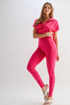 Stylish women's vacation outfit jumpsuit in vibrant pink with a relaxed fit and sleek design