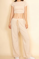Beige crop top and wide-leg pants set, perfect vacation outfits for women for a stylish look