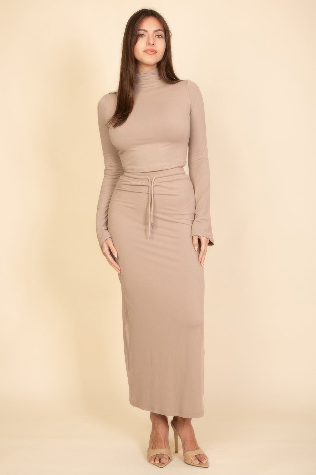 Stylish beige women's outfit set featuring a fitted long-sleeve top and matching maxi skirt, perfect for vacation outfits for women.