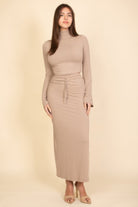 Stylish beige women's outfit set featuring a fitted long-sleeve top and matching maxi skirt, perfect for vacation outfits for women.
