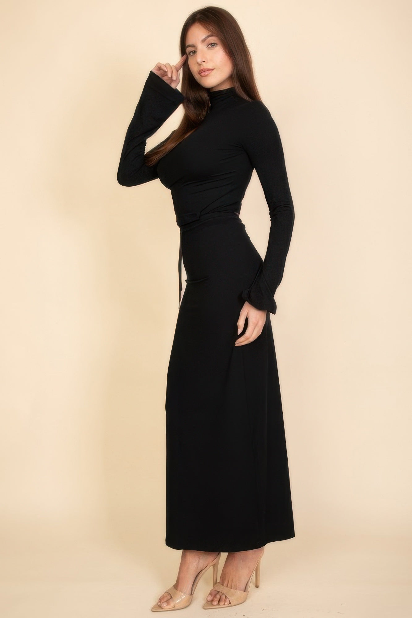 Elegant black vacation outfits for women featuring a fitted top and flowing maxi skirt