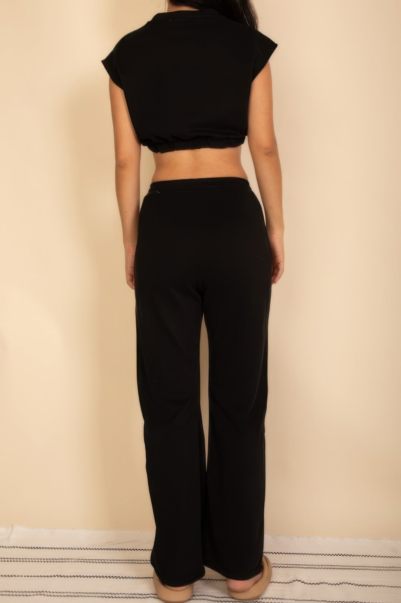 Black women's vacation outfits for women featuring a cropped top and flared pants