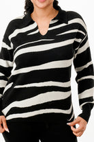 Stylish black and white striped sweater from VacationGrabs, perfect vacation outfits for women