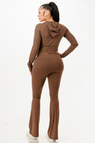 Brown women's outfit set with a cropped hoodie and flared pants, perfect vacation outfits for women