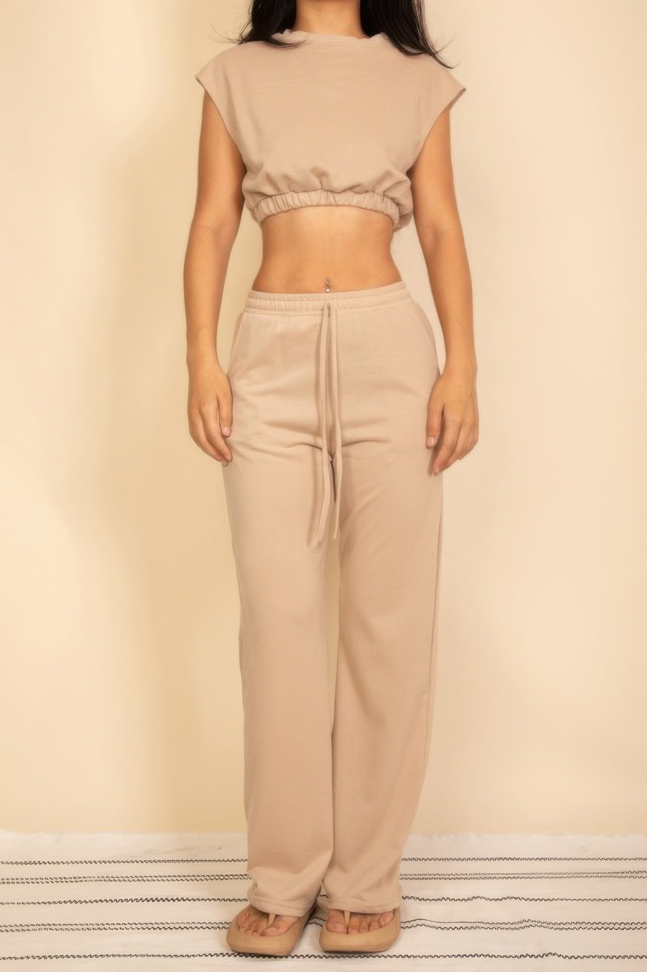 Stylish beige crop top and drawstring pants set, perfect vacation outfits for women