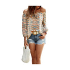 Vacation print long sleeve blouse in pastel colors, styled with denim shorts and a straw bag