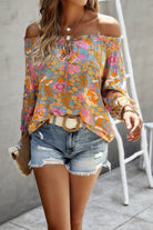 Colorful vacation print long sleeve blouse paired with distressed shorts for a casual summer look