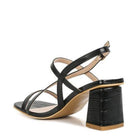Stylish black heels with cross straps, perfect for pairing with outfits, vacation ready sandals white