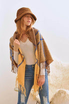 Stylish Bella Chic vacation style accessory featuring a cozy shawl and a chic hat