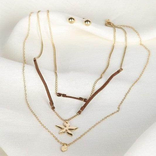 Bella Chic vacation style necklace layered with gold chains and a charm for trendy summer looks