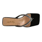 Elegant women's vacation style sandals with a sleek black design and embellished straps
