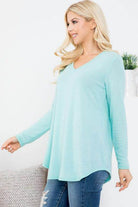 Light blue vacation style v-neck shirt with long sleeves and a relaxed fit for casual wear