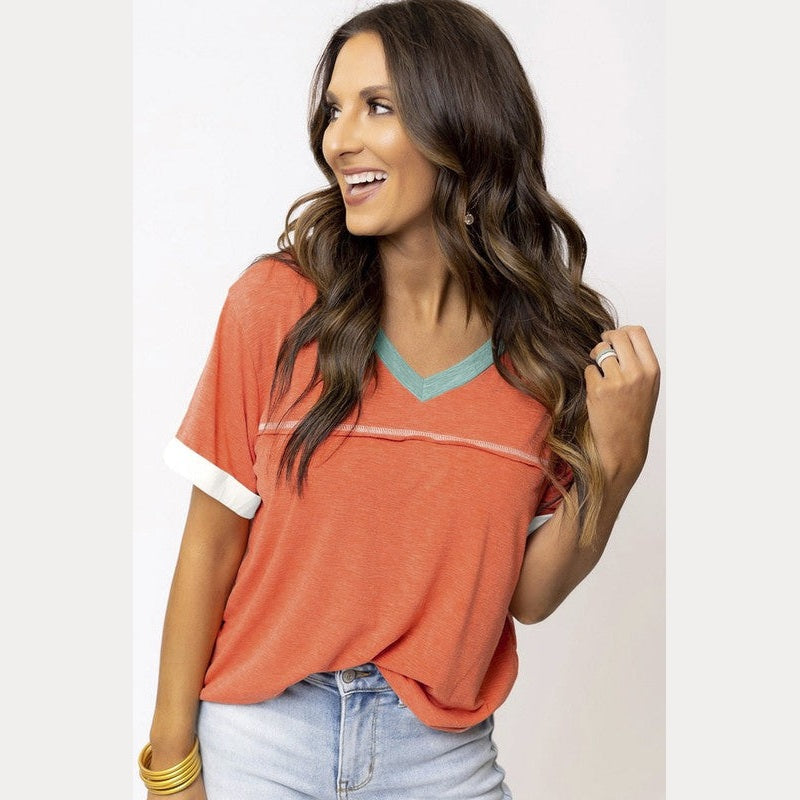 YNIQUE orange vacation style womens t-shirt with teal V-neck and white sleeve cuffs