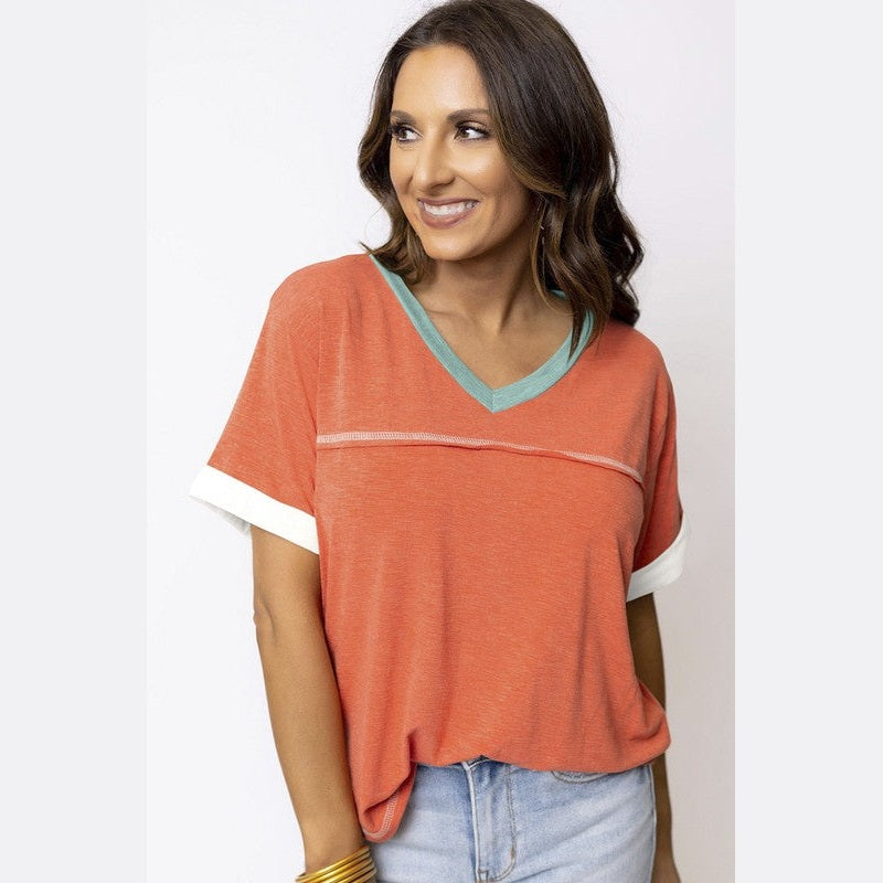 YNIQUE vacation style womens t-shirt in burnt orange with blue neckline and white sleeve cuffs