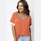 YNIQUE vacation style womens t-shirt in burnt orange with blue neckline and white sleeve cuffs