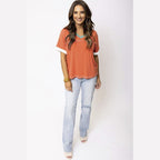 YNIQUE orange and white vacation style womens t-shirt paired with light wash jeans