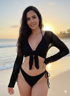 VacationGrabs black bikini set with long-sleeve crochet cover-up worn by a woman on a beach at sunset.