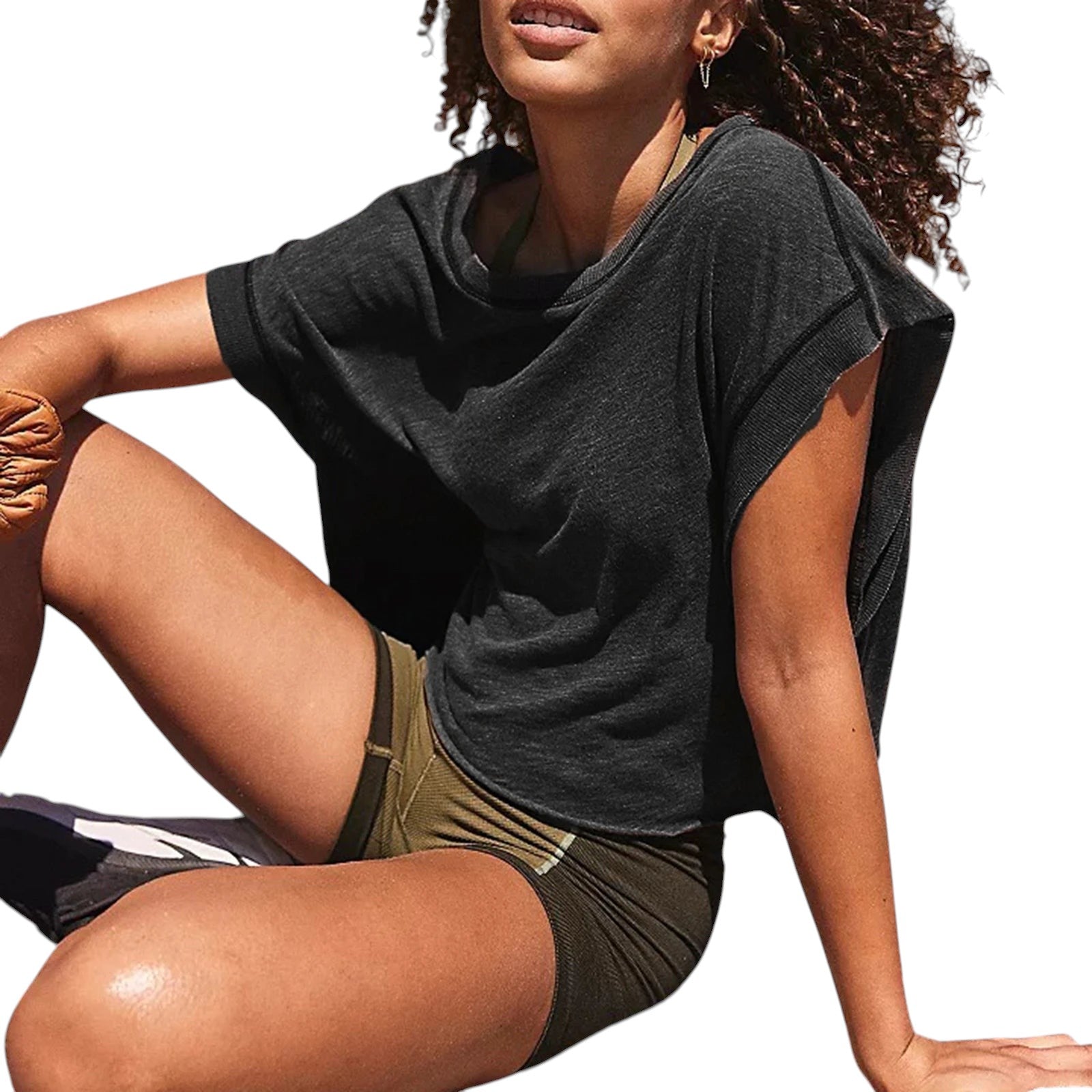 VacationGrabs charcoal grey relaxed crop top with short sleeves worn by a woman on a sunny beach