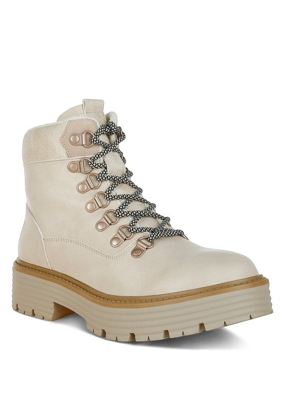 VacationGrabs cream lace-up chunky ankle boots with a thick lug sole and patterned laces for winter travel.