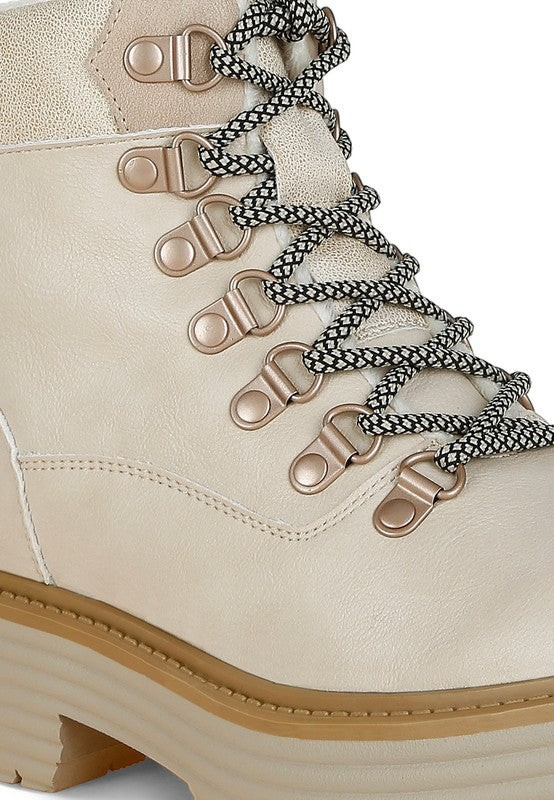 VacationGrabs cream lace-up ankle boots with chunky soles, metallic hardware, and cozy lining for winter travel.