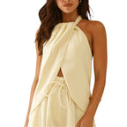 VacationGrabs cream halter-neck top with a cutout front, asymmetric hem, and backless design for a chic travel look.