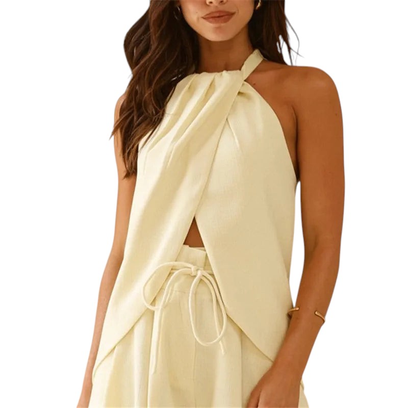 VacationGrabs cream halter-neck top with a cutout front, asymmetric hem, and backless design for a chic travel look.