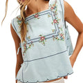 VacationGrabs light blue embroidered floral crop top with a square neckline and tie-up sides for a Y2K vacation look.