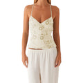 VacationGrabs cream crop top with delicate floral embroidery, sequins, and pearl embellishments on thin spaghetti straps