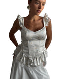 VacationGrabs white corset top with ditsy floral print, ruffle sleeves, and lace trim worn by a model