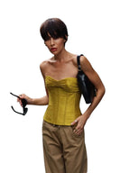 VacationGrabs bright green ruched bandeau corset top worn by a woman with short hair in a casual outdoor setting