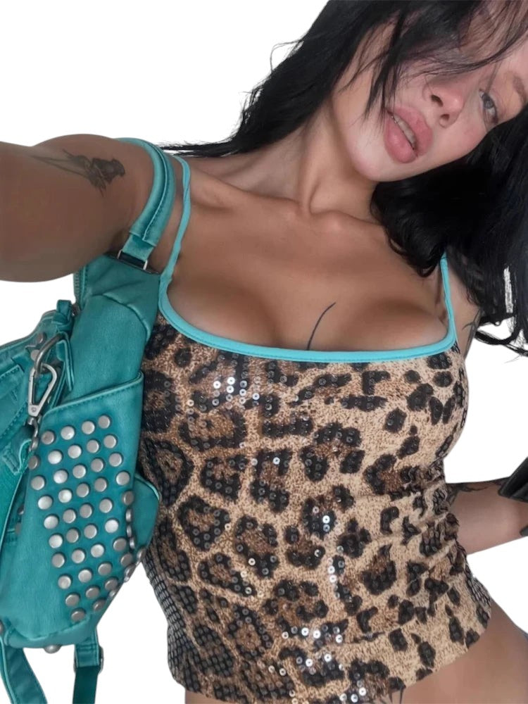 VacationGrabs leopard print sequin tank top with blue trim worn by a woman with a matching teal studded handbag