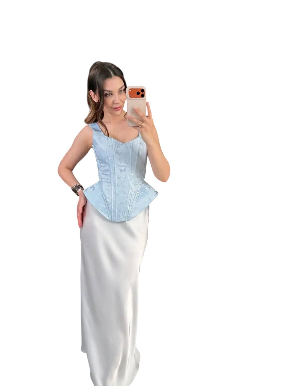 VacationGrabs light blue satin corset top with wide straps and a peplum hem worn by a woman taking a mirror selfie.