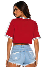 VacationGrabs red cropped cotton t-shirt with white athletic stripe tape on sleeves and a raw hem, worn by a model.