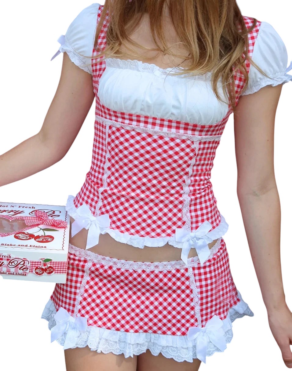 VacationGrabs Y2K style red and white gingham 2-piece set with crop top, lace trim, puffy sleeves, and mini skirt.