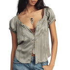 VacationGrabs sage green cropped button-up top with delicate lace trim and short sleeves worn with blue jeans