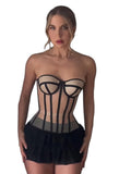 VacationGrabs sheer corset top with beige panels and black piping worn by a woman with a pearl necklace