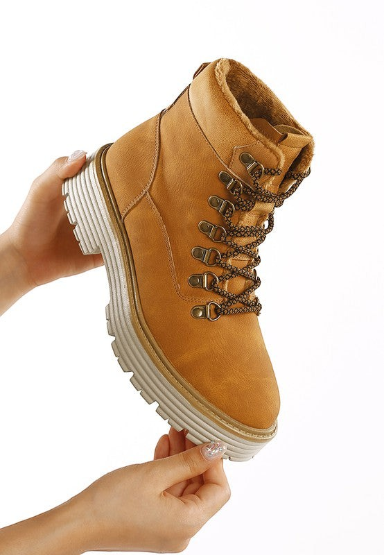VacationGrabs tan lace-up chunky ankle boots with cozy lining and slip-resistant sole held in hand