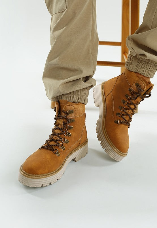 VacationGrabs tan lace-up chunky ankle boots with a cushioned footbed and slip-resistant sole worn with khaki joggers.
