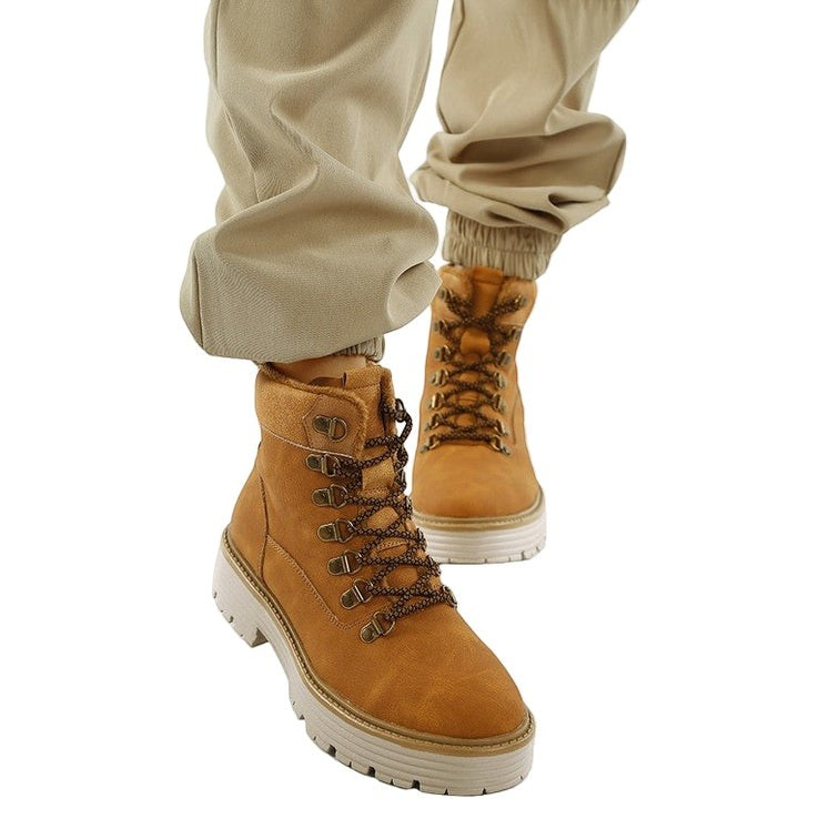 VacationGrabs tan lace-up chunky ankle boots with a cushioned footbed and slip-resistant sole worn with beige joggers.