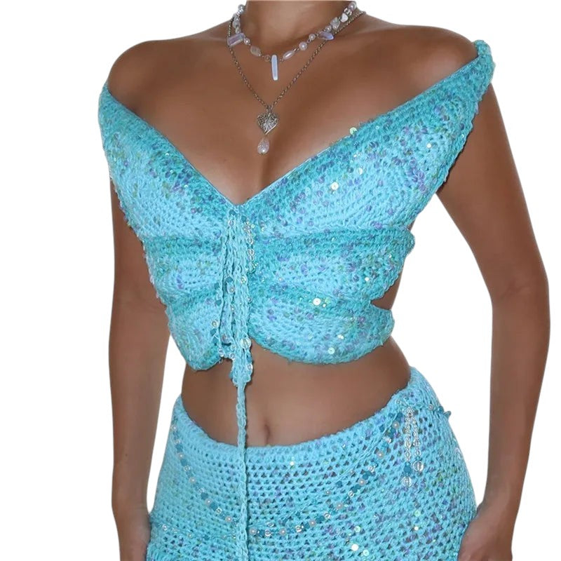 VacationGrabs turquoise crochet butterfly crop top with sequin embellishments, halter neck, and open back design.