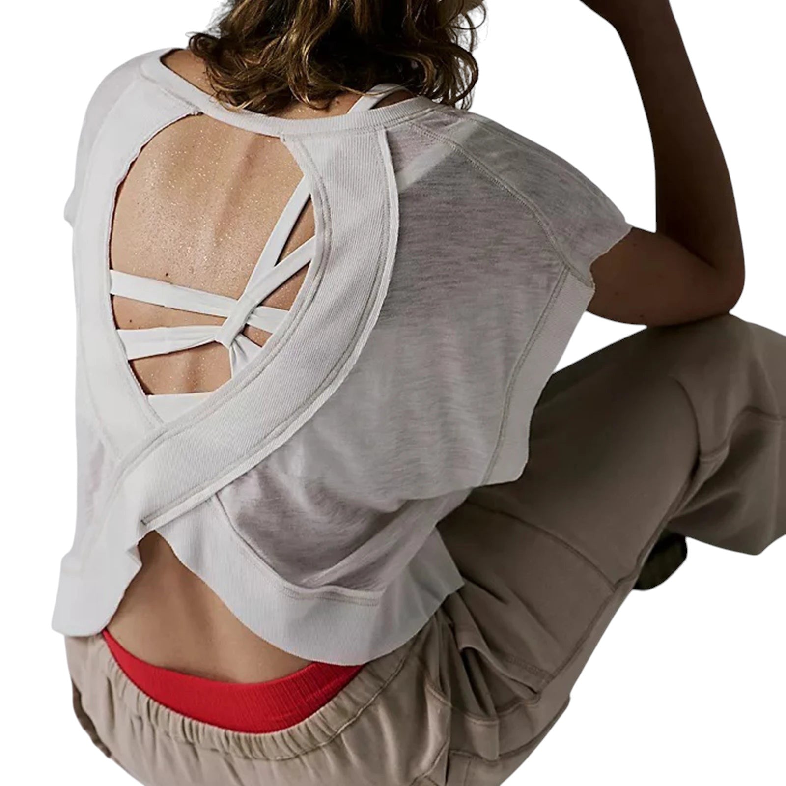 VacationGrabs white short-sleeve crop top with a breezy open cutout back, worn over a sports bra for a casual look.