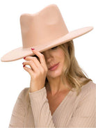 Elegant vegan panama hat in blush color worn by a model for stylish women's accessories