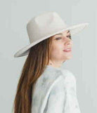 Stylish vegan panama hat in white worn by a woman with long hair, perfect for sunny days